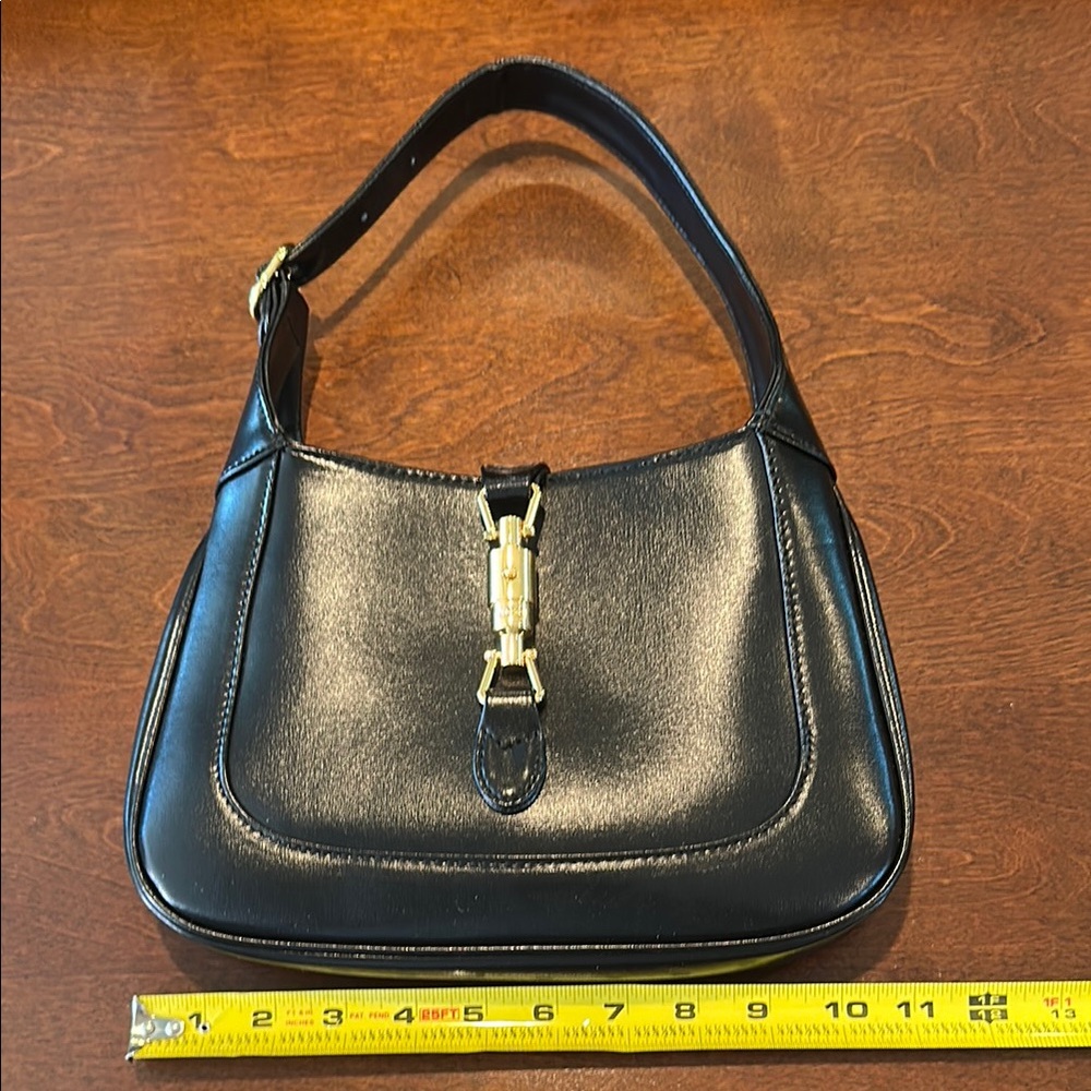Elegant Black and Gold Shoulder Bag with Hobo Design